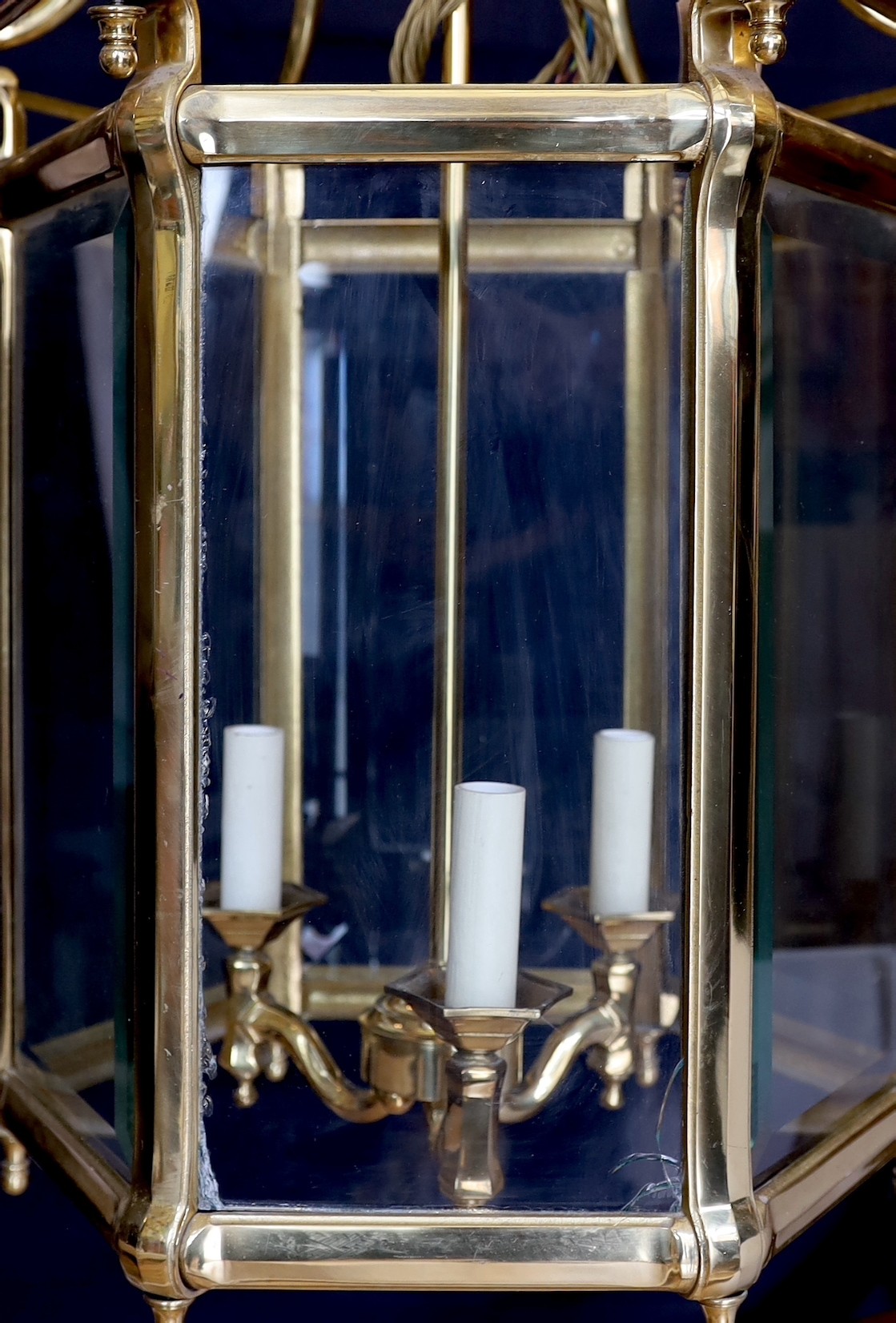 A large Georgian style hexagonal brass hall lantern with bevelled glass plates, height 79cm. width 48cm